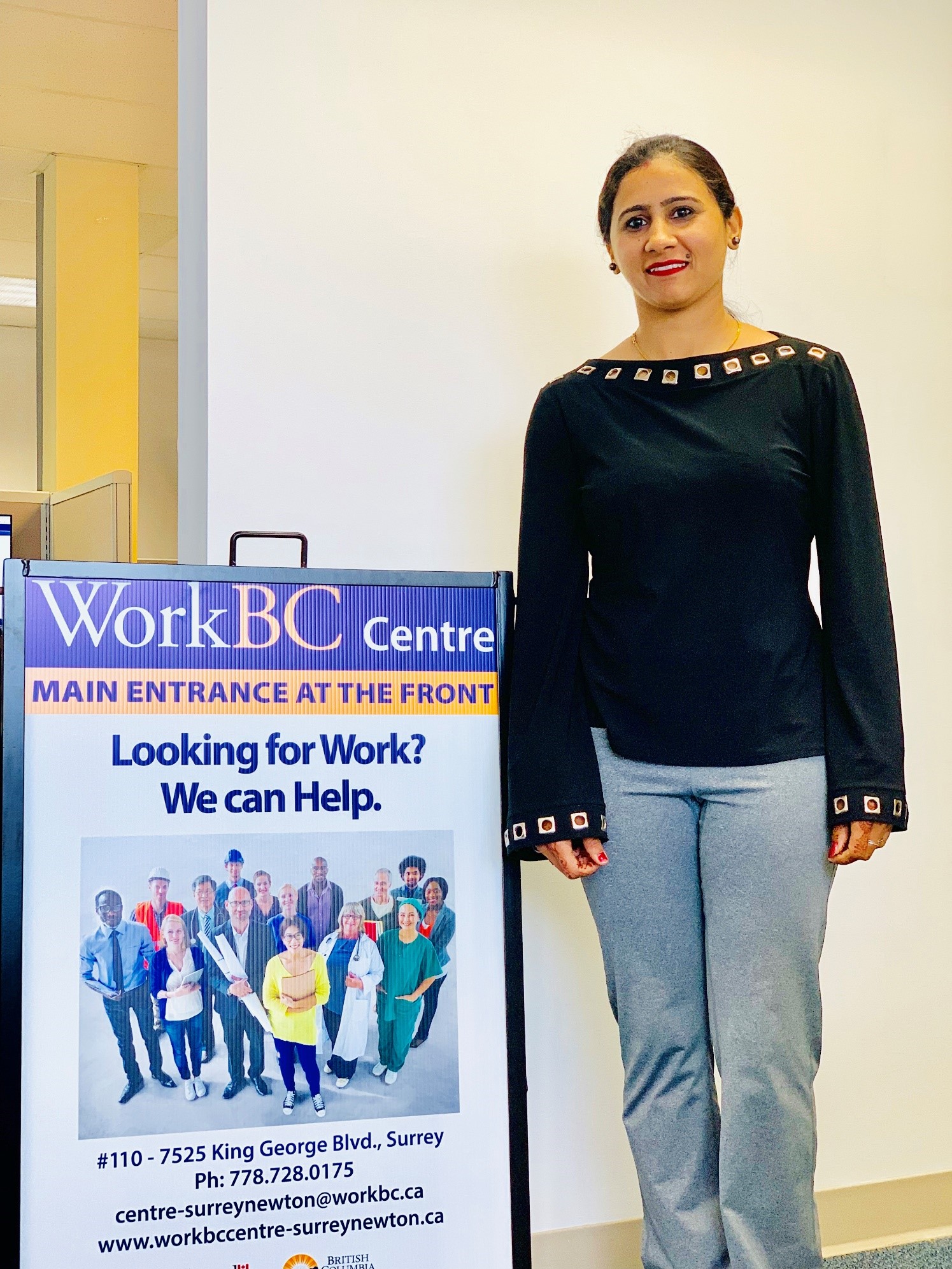 Woman standing next to WorkBC barrier